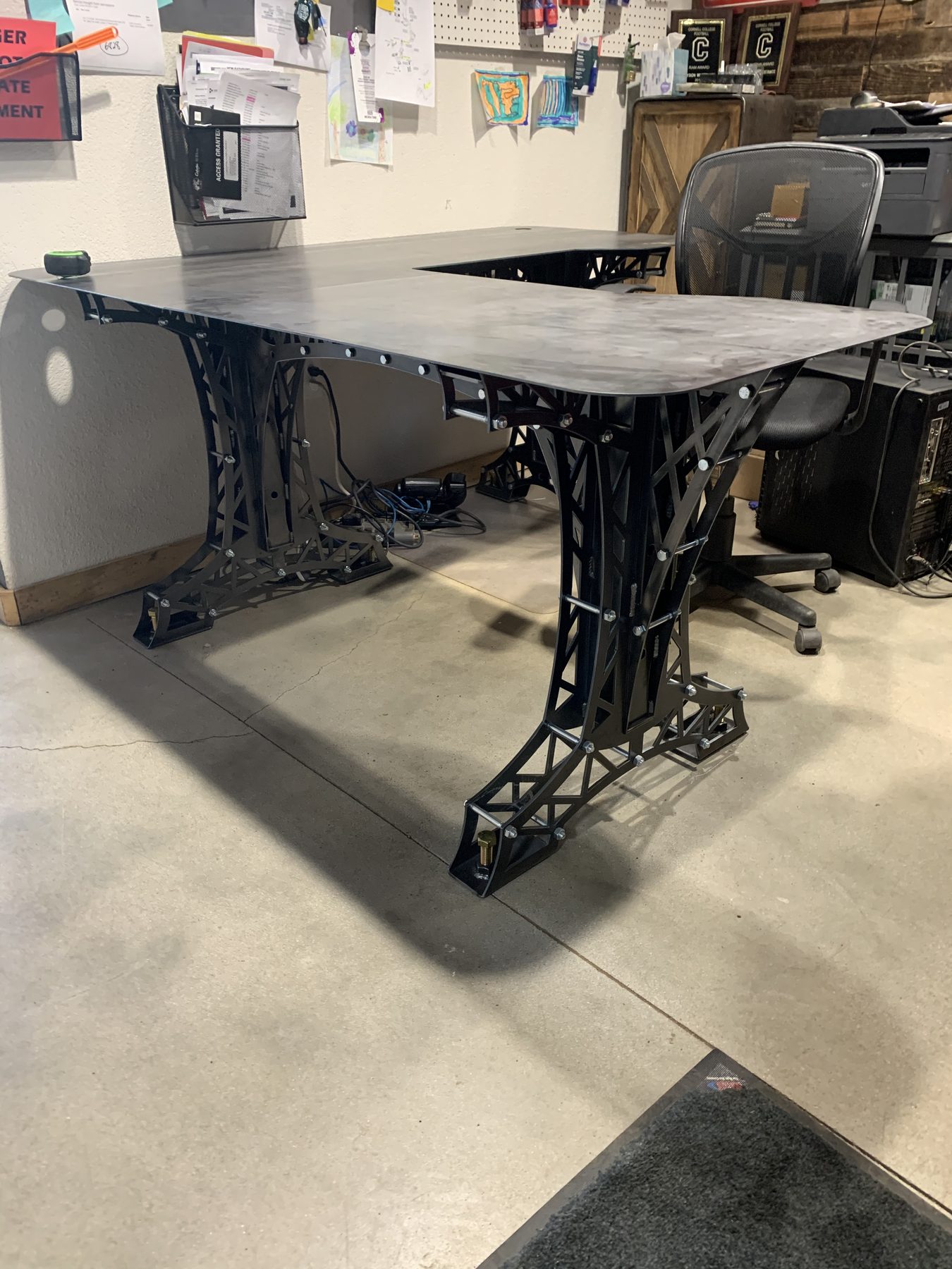 Custom industrial truss-leg desk built at ArcWest Fabrication