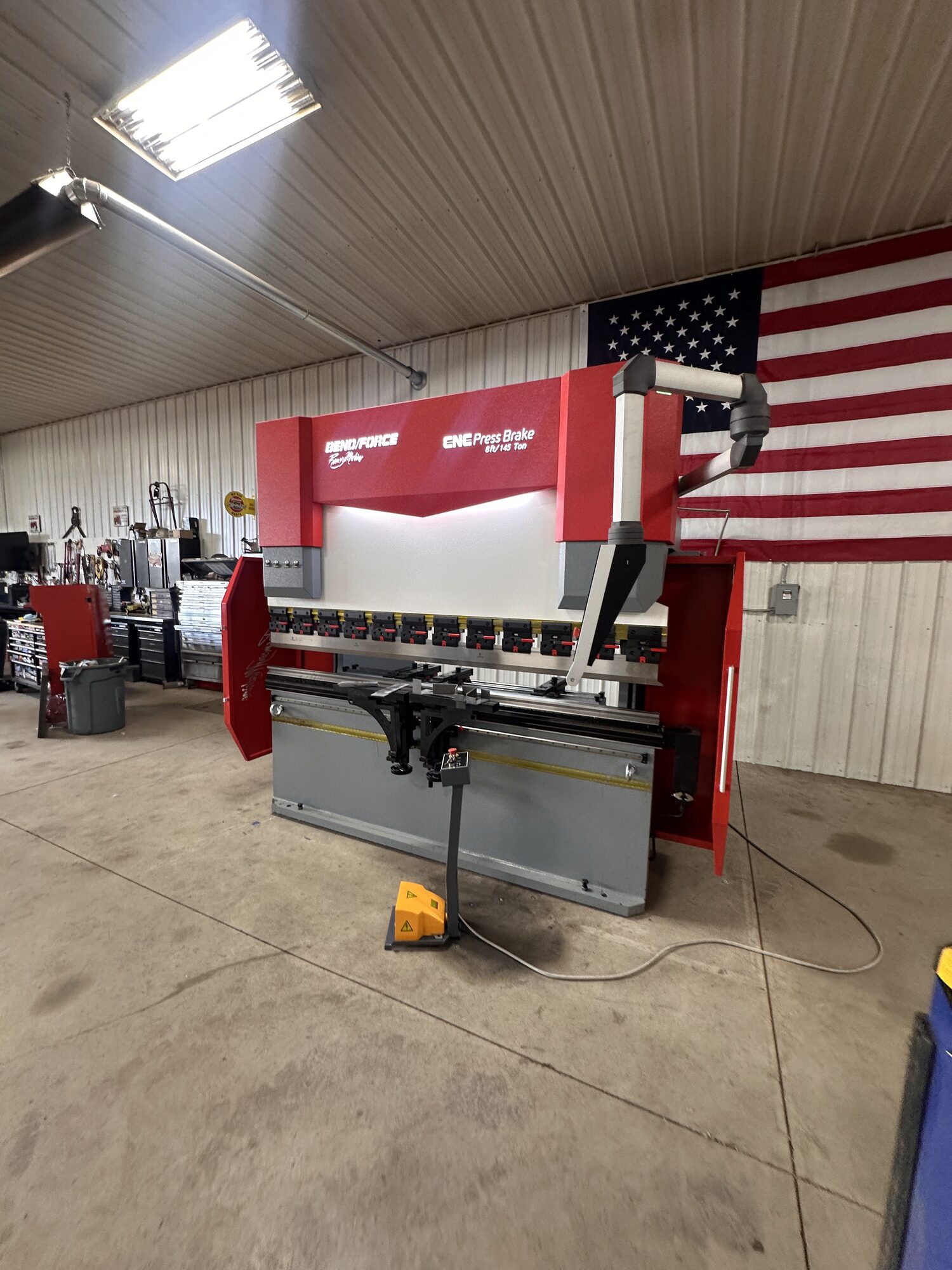 ArcWest 145-ton Bend/Force Ramsey CNC press brake on the shop floor with American flag