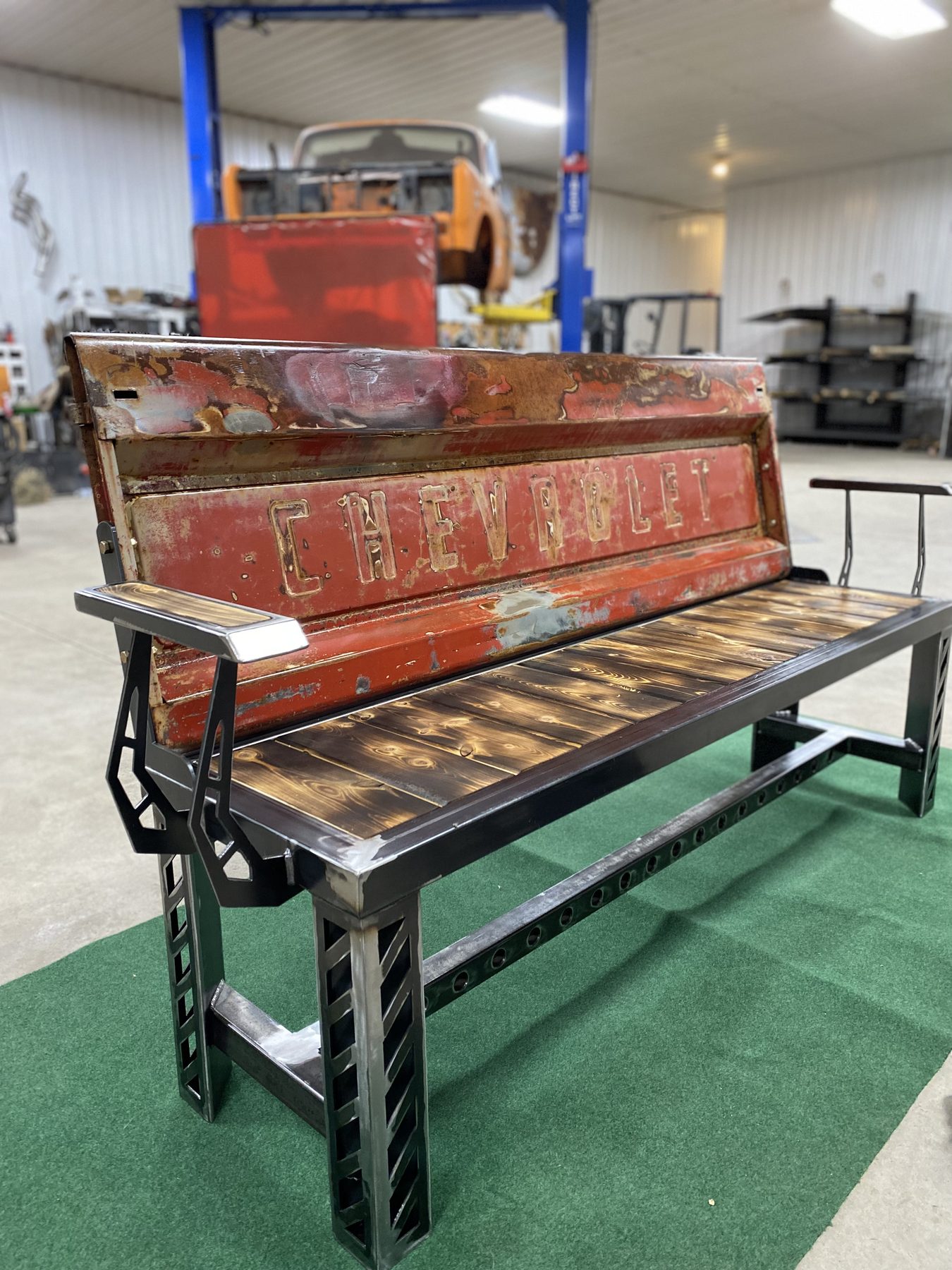 Custom Chevy tailgate bench with steel frame and reclaimed wood seat