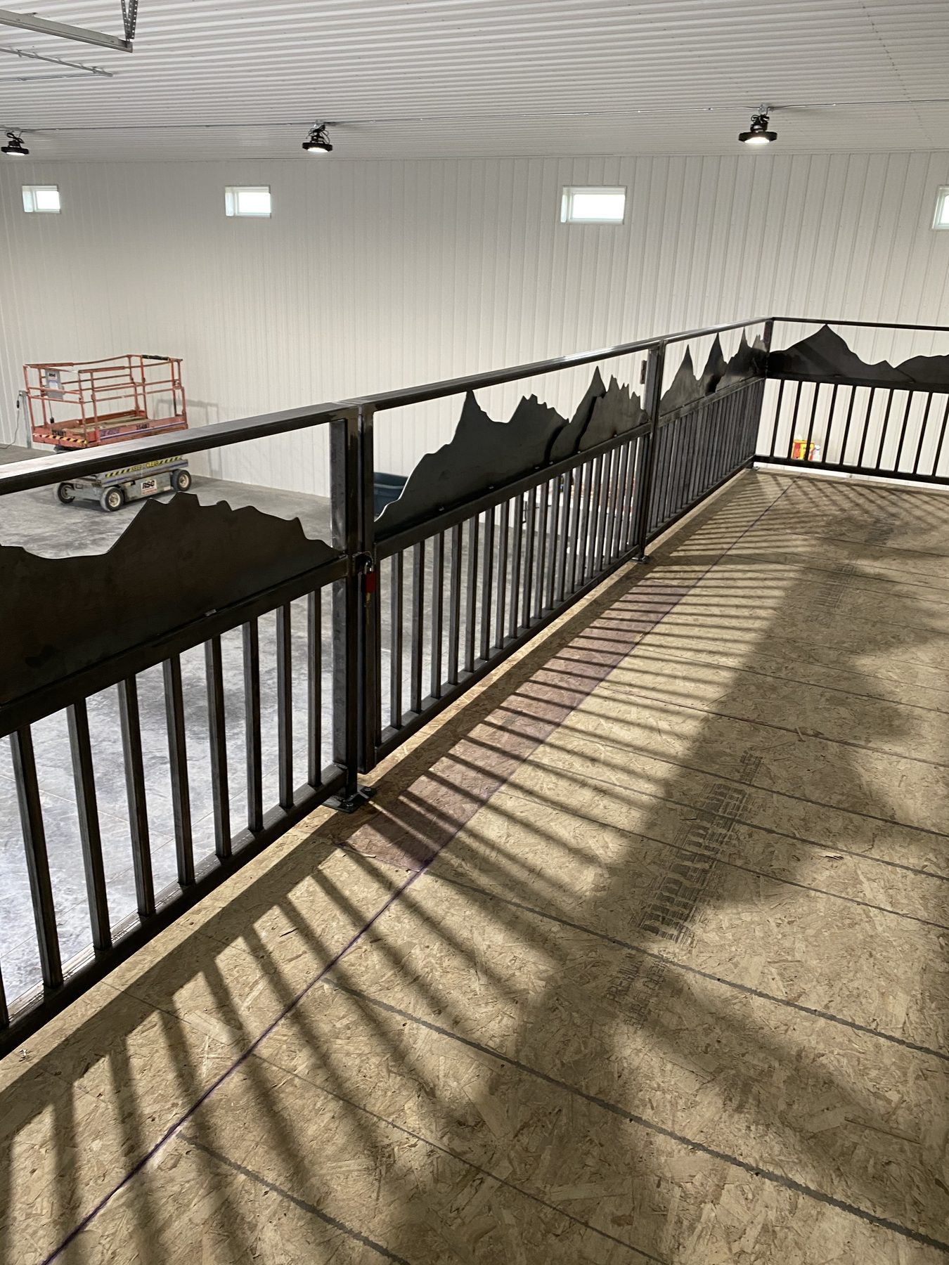 Plasma-cut Colorado mountain-silhouette railing fabricated at ArcWest