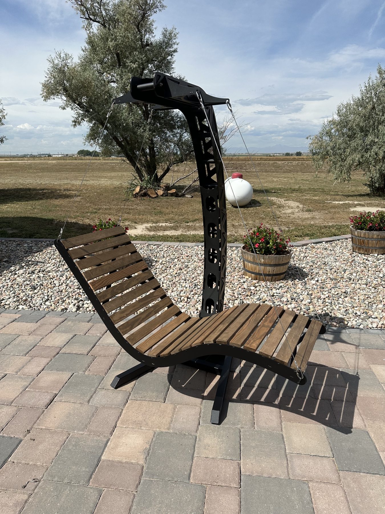 Outdoor steel and wood lounge chair with sun and cactus design
